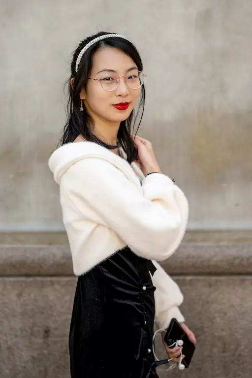 a picture of an asian woman wearing a white sweater and black skirt. Image before image to Image anime conversion